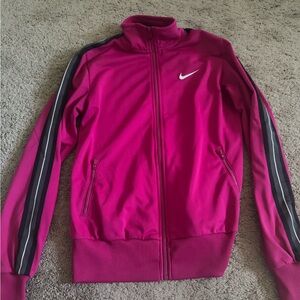 A magenta Nike track suit zip up. Worn a couple of times